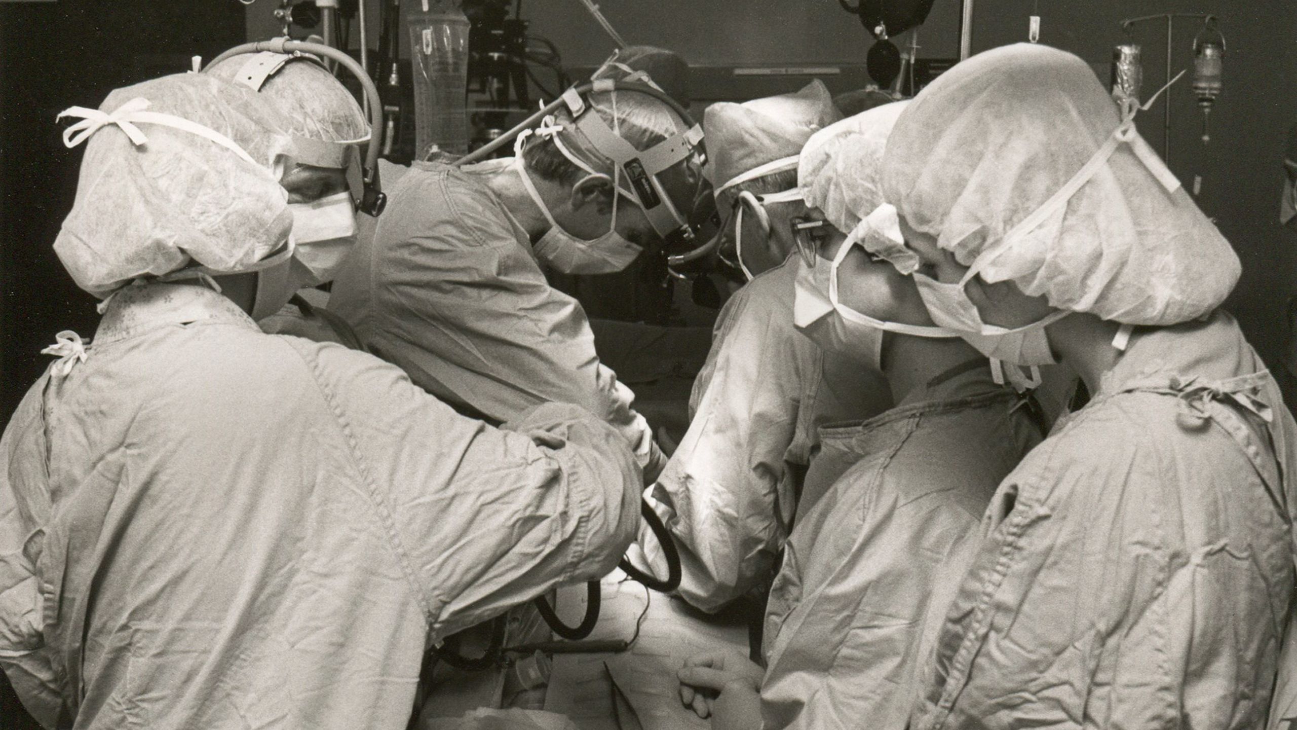 Surgeons operating on a patient with heart failure.