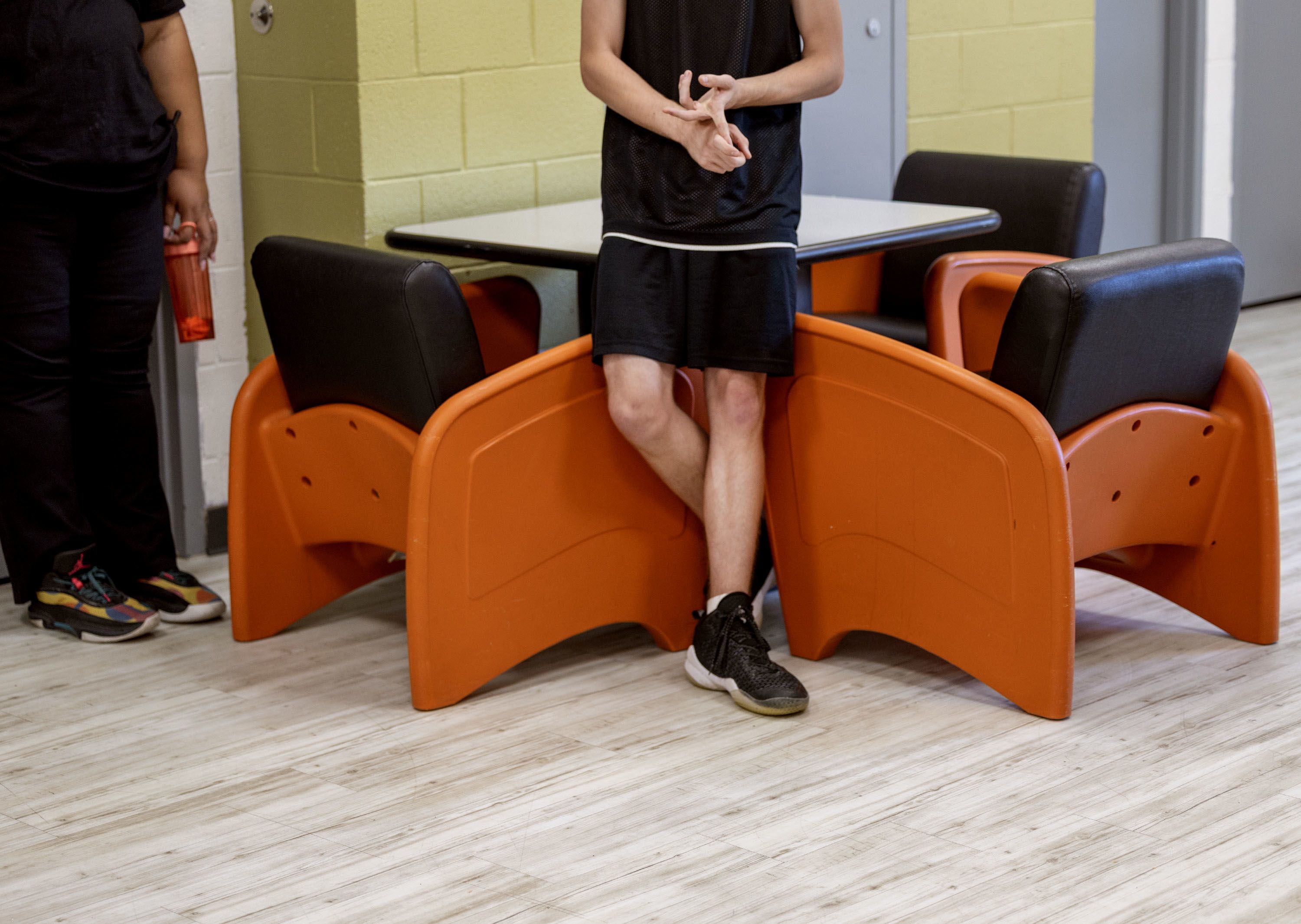 A youth (right) and unit supervisor (left) inside the community room at Decker Lake Youth Center. 