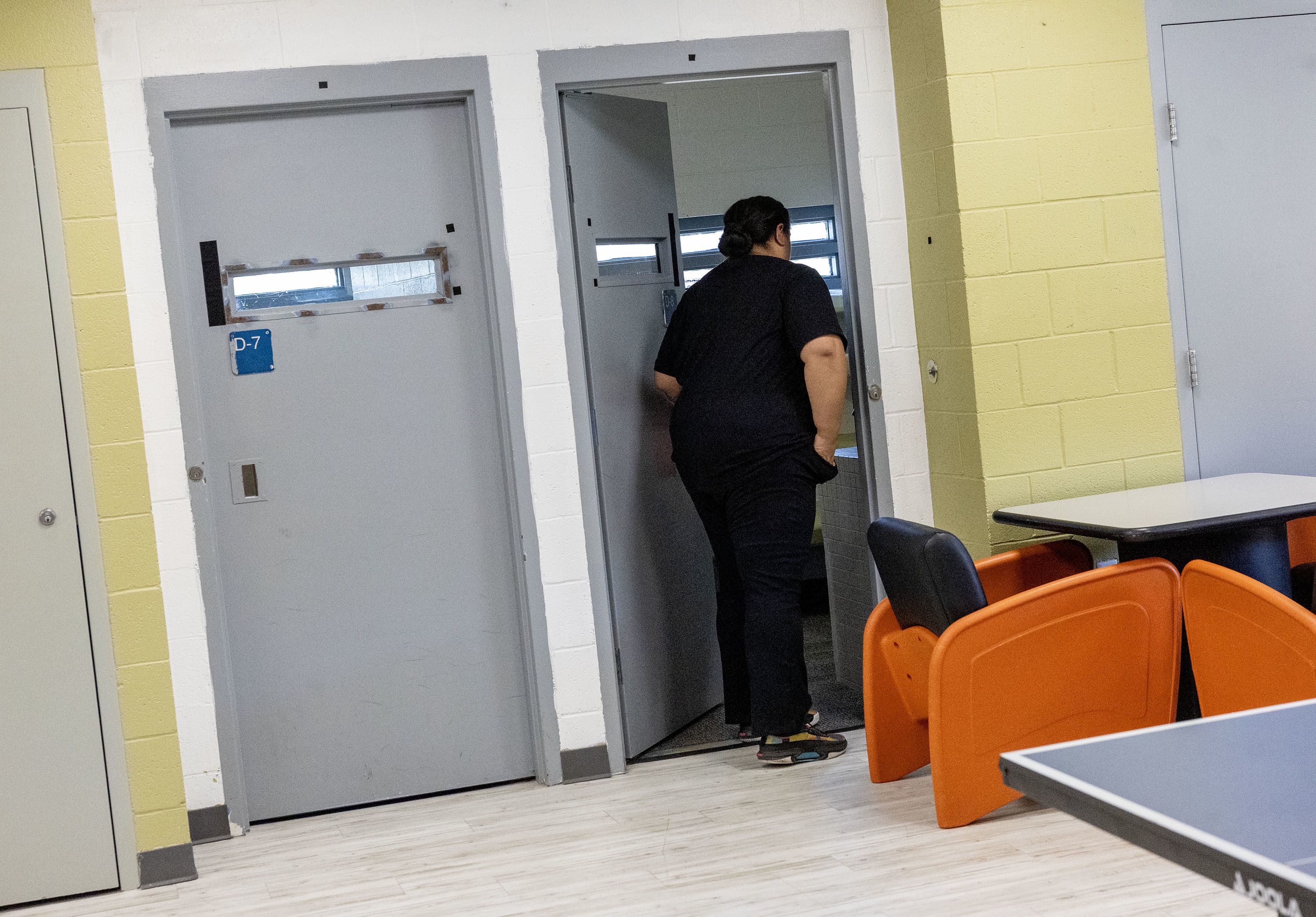 Kalesita Nasilai, a unit supervisor at Decker Lake Youth Center, opens the door of a cell.