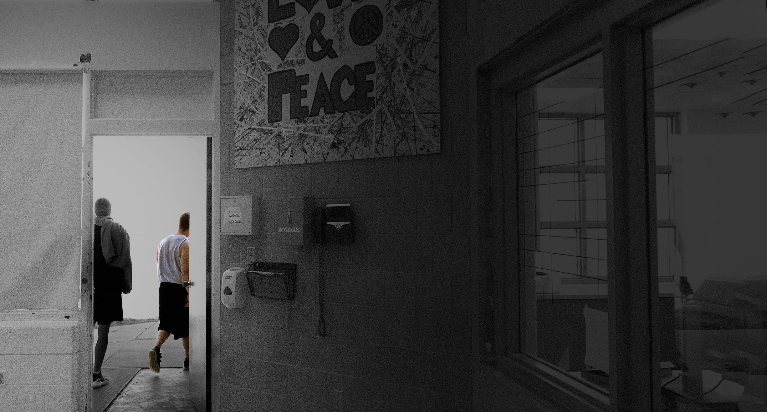 A youth walks out the door alongside unit supervisor [NAME] in the community room at Decker Lake Youth Center.