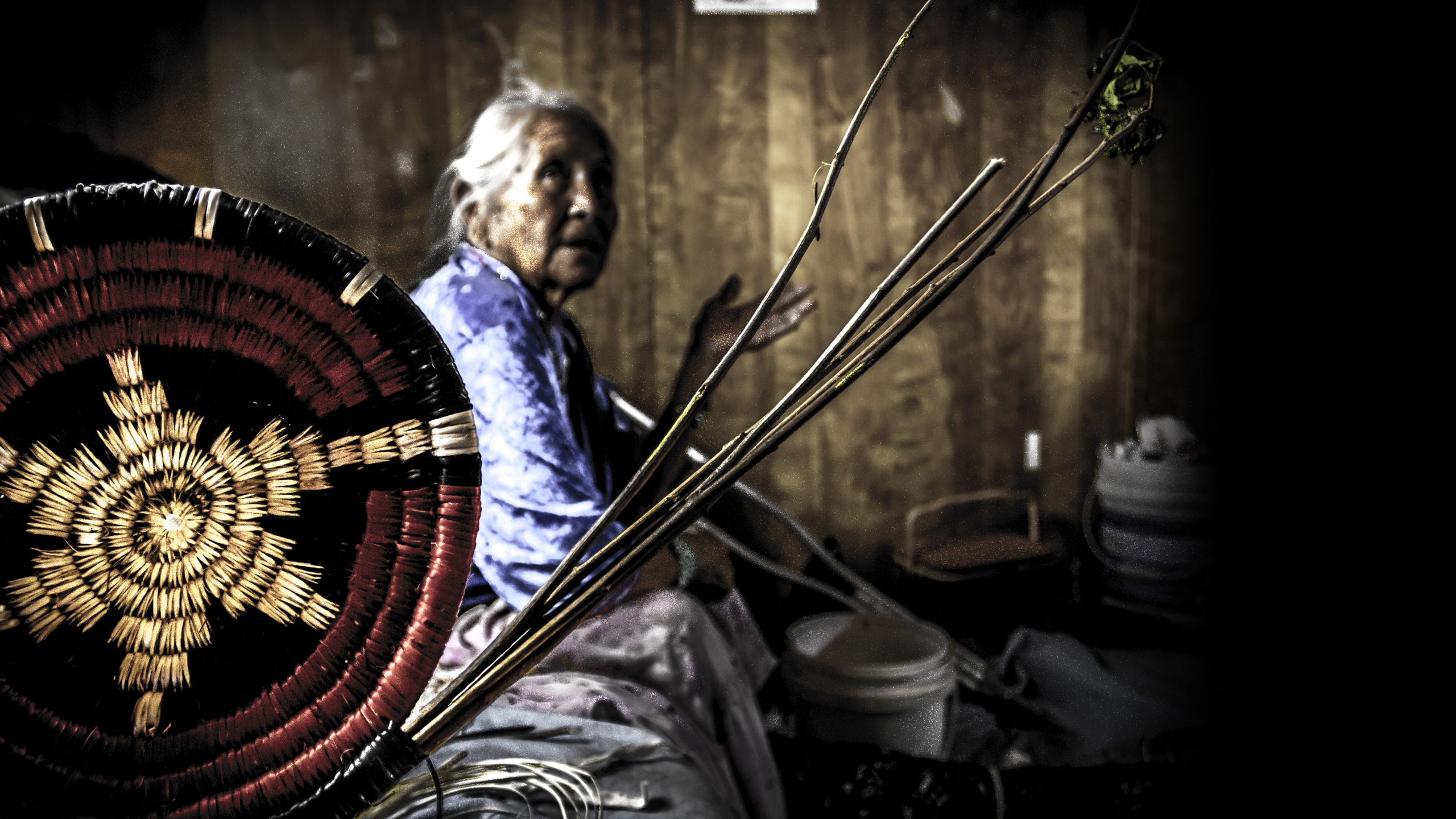 A Navajo basket weaver at home