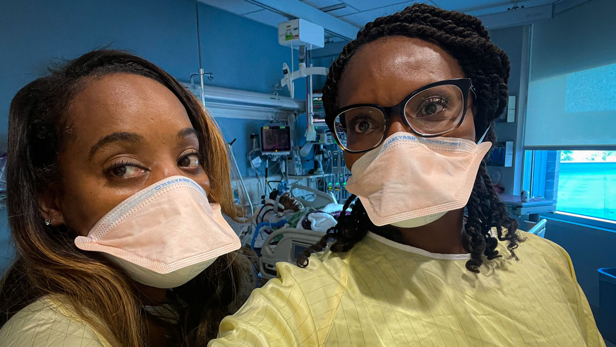 Nakia takes a selfie of her and LaShonda, both wearing masks, with Manny unconscious in his bed directly behind them.
