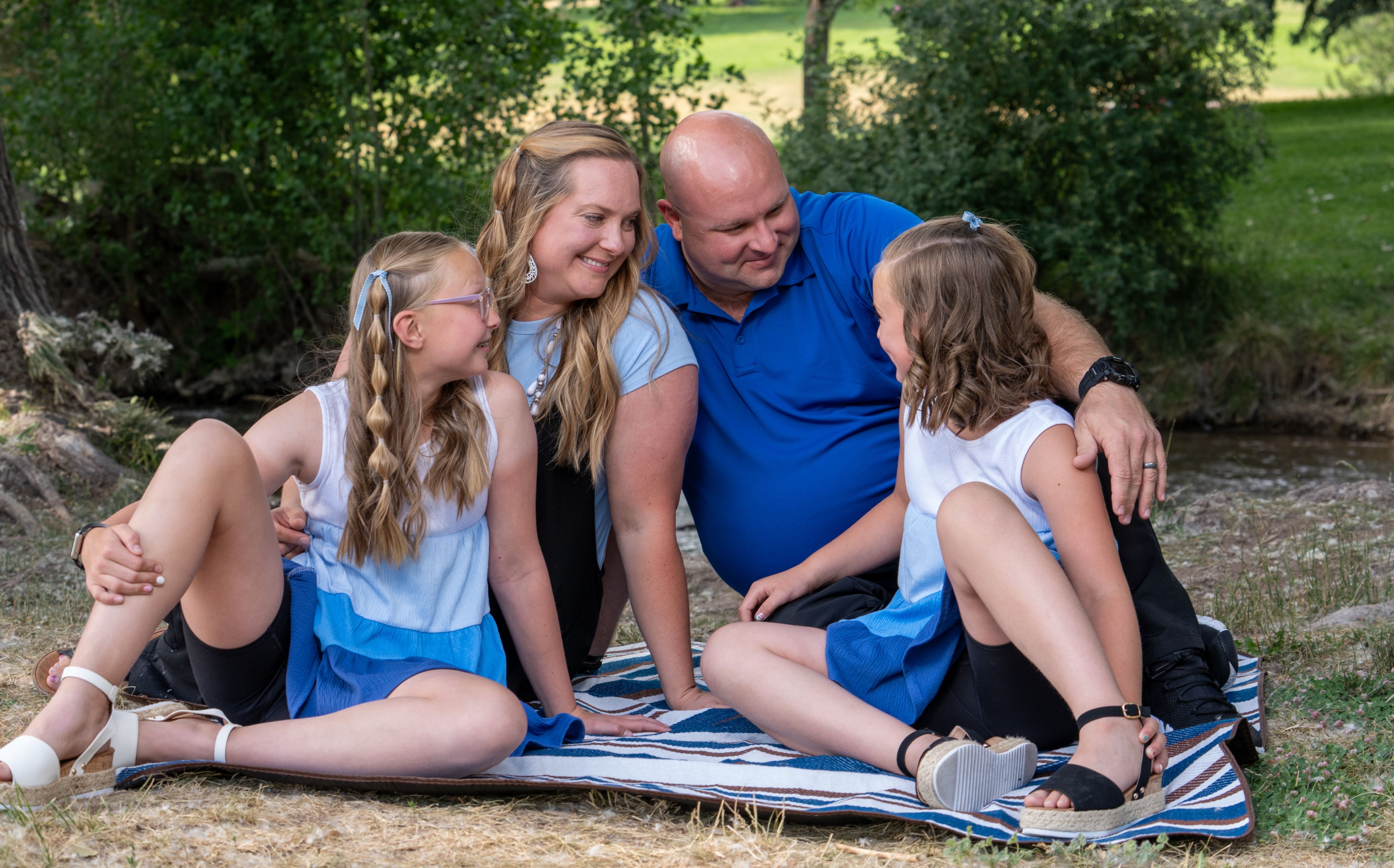 Photo of Cody Harris with his wife and daughters laughing